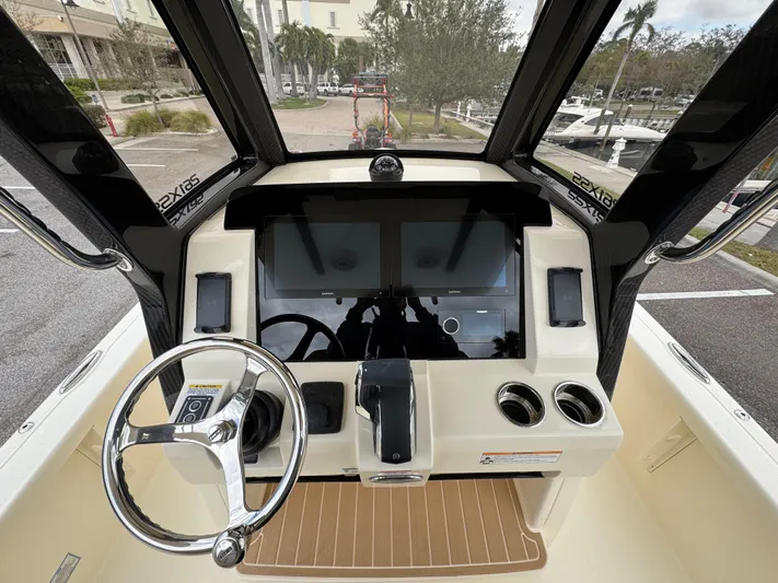  Yacht Photos Pics 2025 Scout 261 XSS boat dashboard with steering wheel and dual screens.