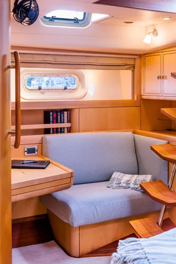 Ravenclaw Yacht Photos Pics Luxurious interior of 2007 Oyster 82/08 yacht with cozy seating and elegant wood finishes.