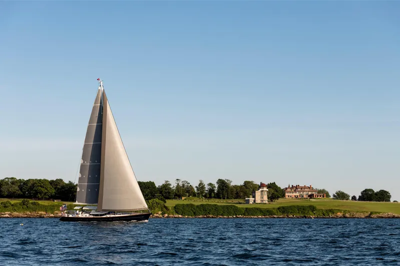 Ravenclaw Yacht Photos Pics Sailing yacht Oyster 82/08 (2007) on open water near a coastal estate.