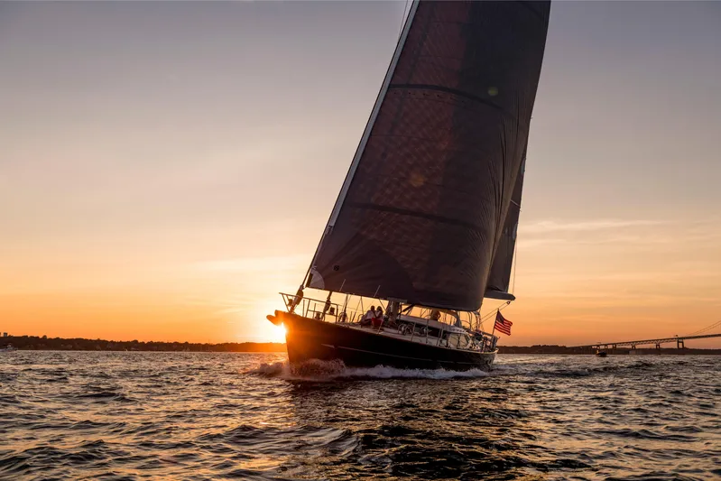 Ravenclaw Yacht Photos Pics Sailing yacht Oyster 82/08 at sunset, 2007 model, gliding on open water.