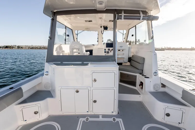 Caroline II Yacht Photos Pics 2021 NorthCoast 285 HT boat interior with seating and storage, on calm water.