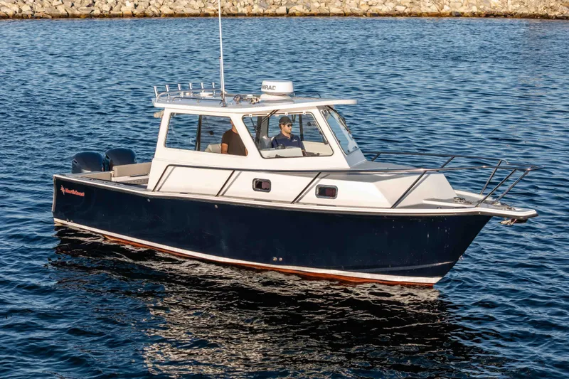 Caroline II Yacht Photos Pics 2021 NorthCoast 285 HT boat cruising on calm blue water.