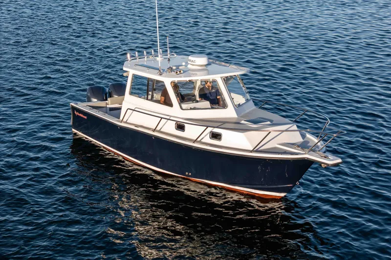 Caroline II Yacht Photos Pics 2021 NorthCoast 285 HT boat cruising on calm blue water.
