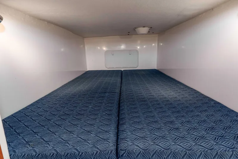 Caroline II Yacht Photos Pics 2021 NorthCoast 285 HT cabin interior with blue patterned bedding.