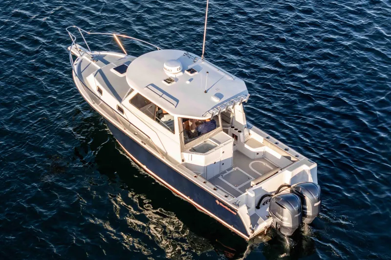 Caroline II Yacht Photos Pics 2021 NorthCoast 285 HT boat on water, featuring dual outboard engines.