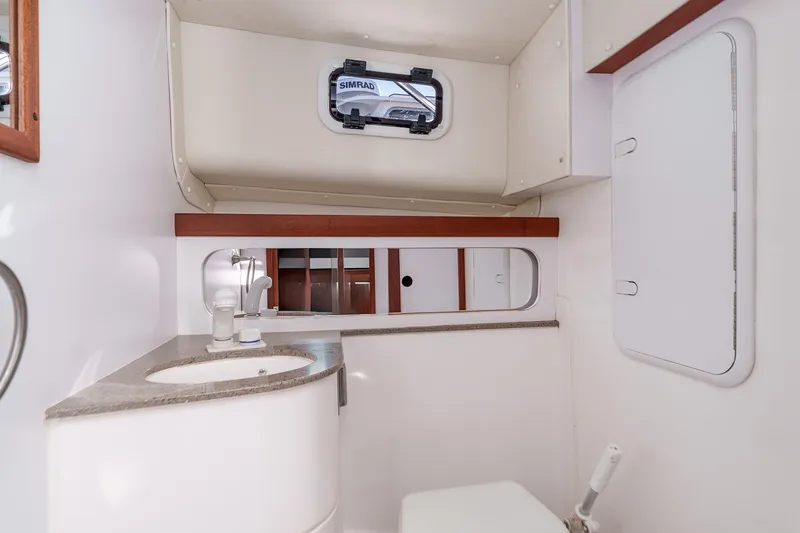 Caroline II Yacht Photos Pics 2021 NorthCoast 285 HT boat bathroom with sink, mirror, and storage.