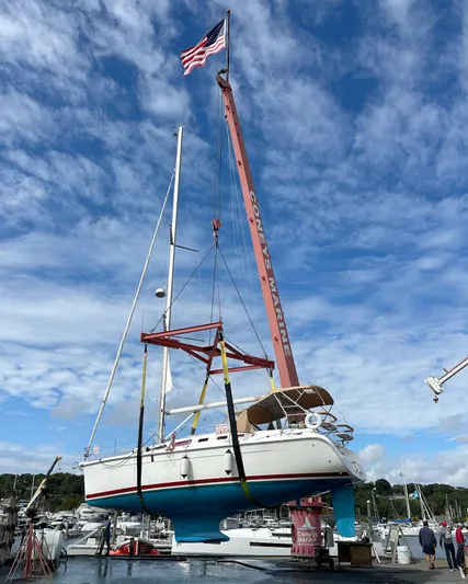 Yacht Photos Pics A 2005 Hunter 38 sailboat being lifted by a crane at a marina.