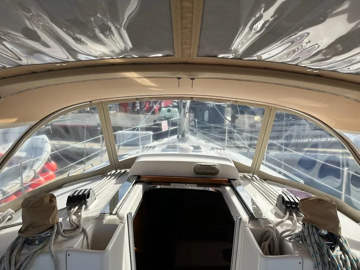  Yacht Photos Pics Interior view of 2005 Hunter 38 sailboat cockpit with ropes and covered equipment.