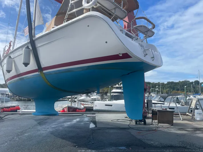  Yacht Photos Pics Sailboat Hunter 38 (2005) on dry dock, blue hull, marina background.