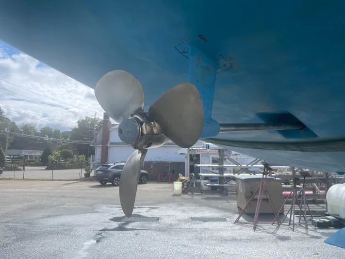  Yacht Photos Pics Propeller of a 2005 Hunter 38 sailboat on dry dock, under clear sky.