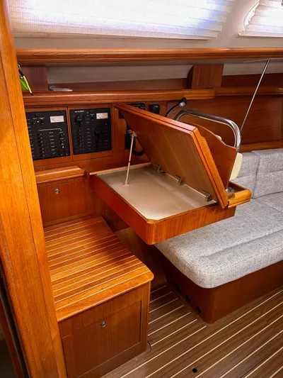  Yacht Photos Pics 2005 Hunter 38 yacht interior with wooden cabinetry and foldable navigation desk.