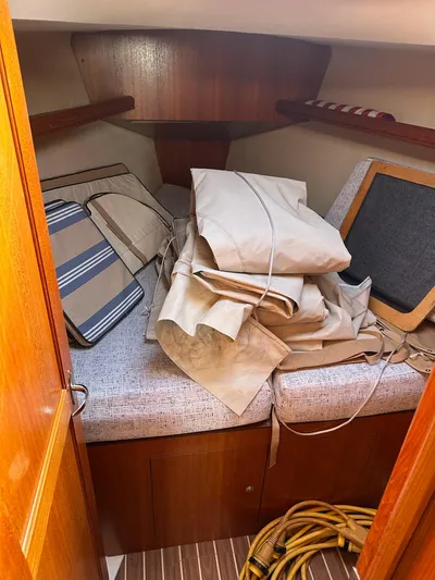  Yacht Photos Pics Interior cabin of 2005 Hunter 38 sailboat with cushions and folded sails.