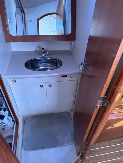  Yacht Photos Pics Compact bathroom in a 2005 Hunter 38 sailboat with sink and mirror.