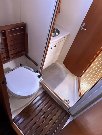  Yacht Photos Pics 2005 Hunter 38 yacht bathroom with toilet, sink, and wooden flooring.