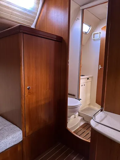  Yacht Photos Pics Interior of 2005 Hunter 38 sailboat with wooden cabinetry and compact bathroom.