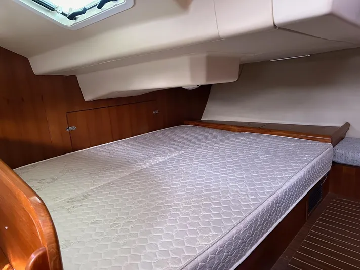  Yacht Photos Pics 2005 Hunter 38 yacht interior cabin with comfortable mattress and wooden accents.