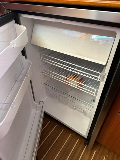  Yacht Photos Pics Open refrigerator with empty shelves inside a 2005 Hunter 38 boat.