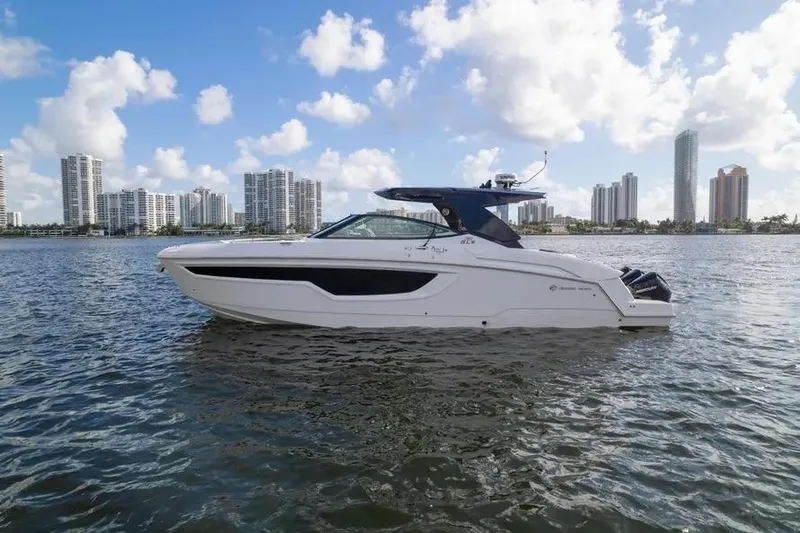  Yacht Photos Pics 2021 Cruisers Yachts 38 GLS OB on water with city skyline backdrop.