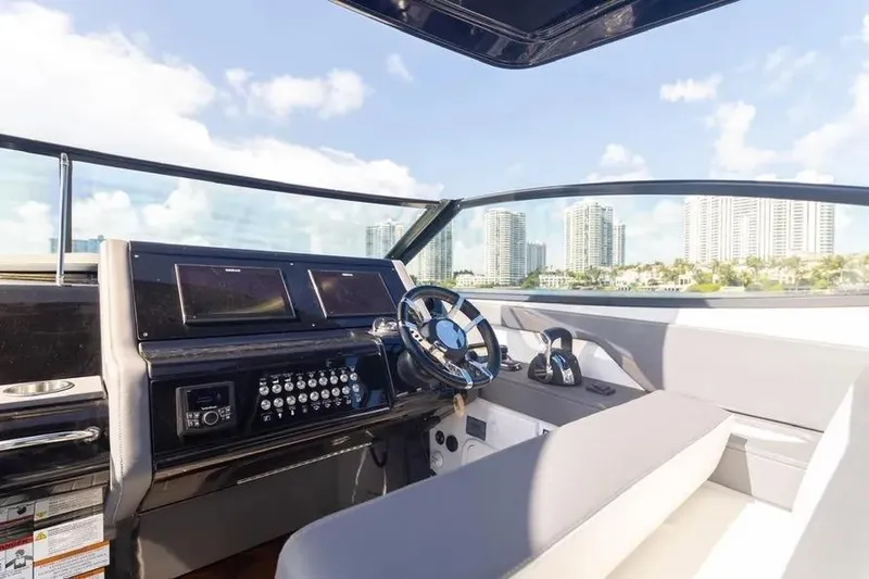  Yacht Photos Pics 2021 Cruisers Yachts 38 GLS OB helm with city skyline view.