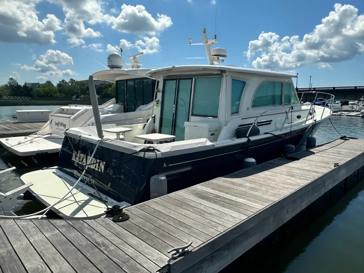 Katahdin Yacht Photos Pics 2020 Back Cove 41 yacht docked at marina under a partly cloudy sky.