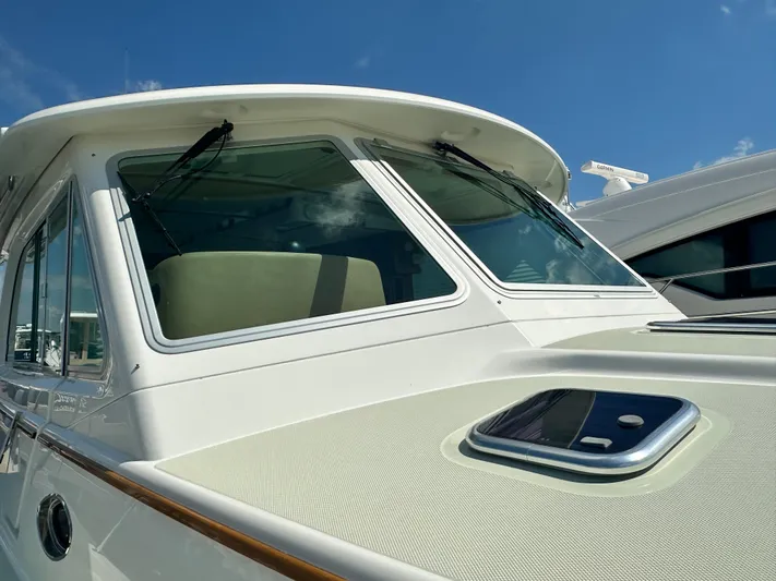 Katahdin Yacht Photos Pics 2020 Back Cove 41 yacht, close-up of cabin windows and deck, under clear blue sky.