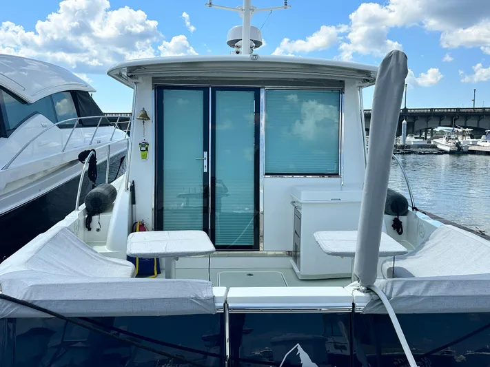 Katahdin Yacht Photos Pics 2020 Back Cove 41 yacht docked, featuring a spacious rear deck and sliding glass doors.