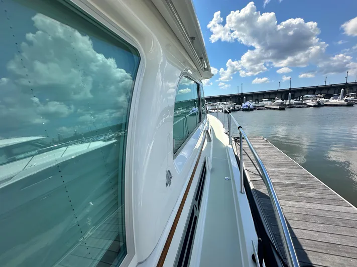Katahdin Yacht Photos Pics Back Cove 41 yacht docked at marina, reflecting blue sky and clouds, 2020 model.