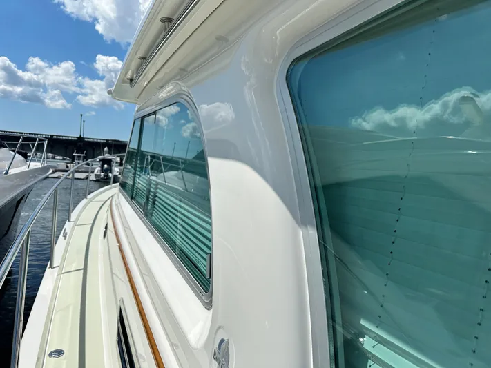 Katahdin Yacht Photos Pics 2020 Back Cove 41 yacht with sleek design and large windows, docked under a sunny sky.