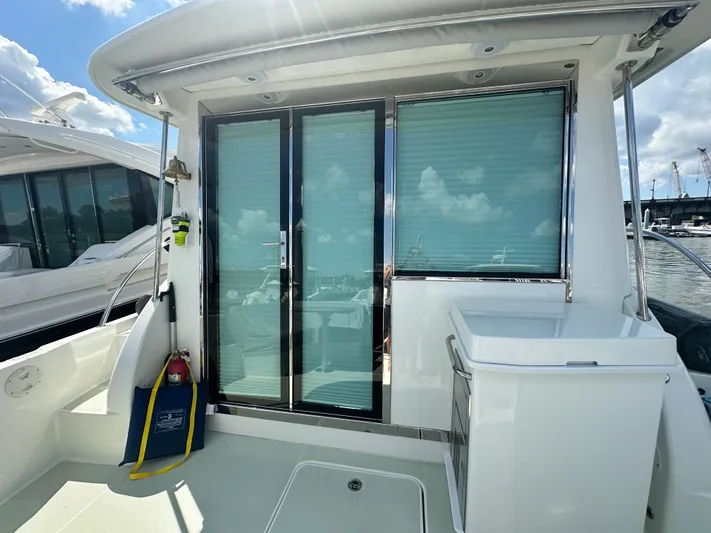 Katahdin Yacht Photos Pics 2020 Back Cove 41 yacht with sliding glass doors and outdoor seating area.