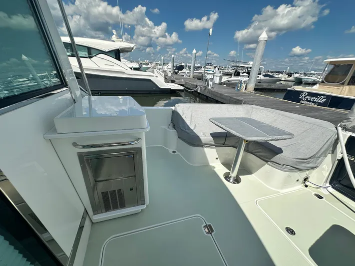 Katahdin Yacht Photos Pics 2020 Back Cove 41 yacht deck with seating and table, docked at marina.
