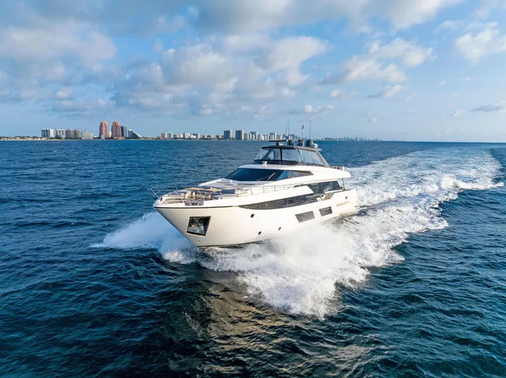  Yacht Photos Pics 2020 Ferretti Yachts 920 cruising on open water with city skyline in background.