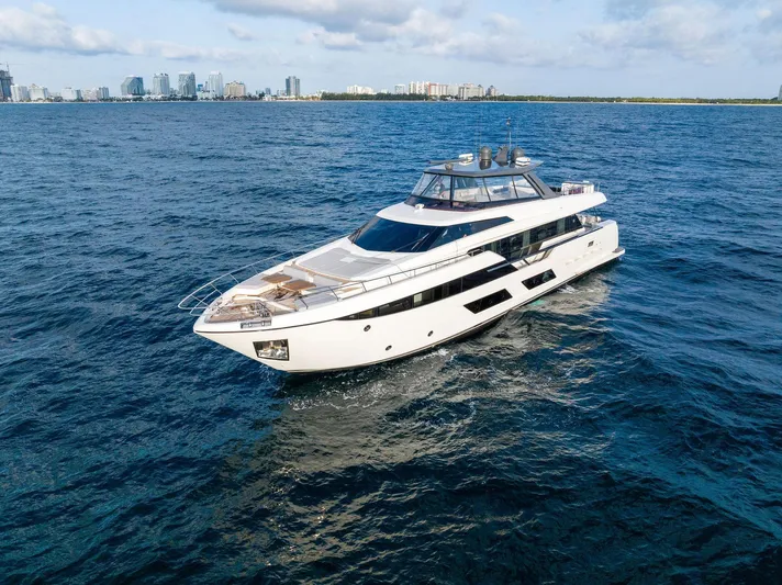  Yacht Photos Pics 2020 Ferretti Yachts 920 cruising on open water with city skyline in background.