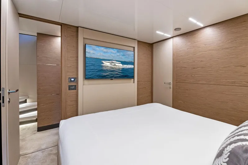  Yacht Photos Pics Luxurious bedroom interior of 2020 Ferretti Yachts 920 with modern design and wall-mounted TV.