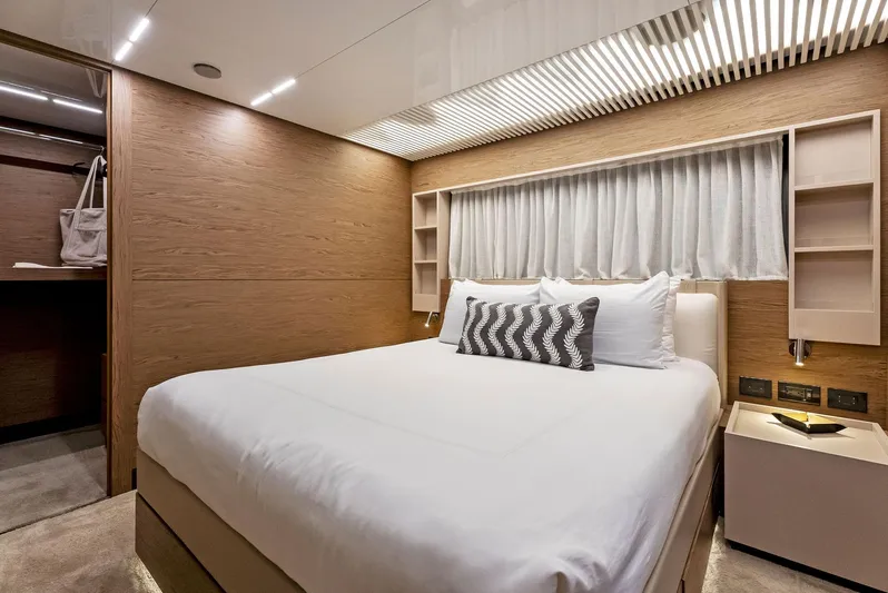  Yacht Photos Pics Luxurious bedroom interior of 2020 Ferretti Yachts 920, featuring modern design and cozy bedding.