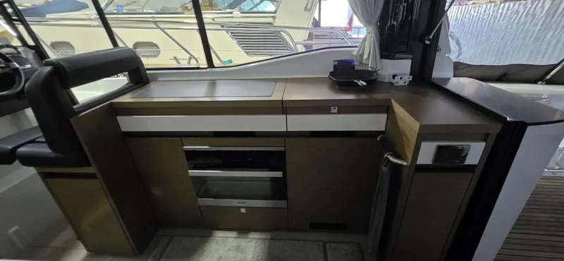  Yacht Photos Pics 2020 Jeanneau NC 37 yacht interior kitchen with modern cabinetry and appliances.