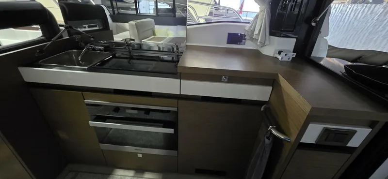  Yacht Photos Pics Modern kitchen interior of 2020 Jeanneau NC 37 yacht with sleek appliances and cabinetry.