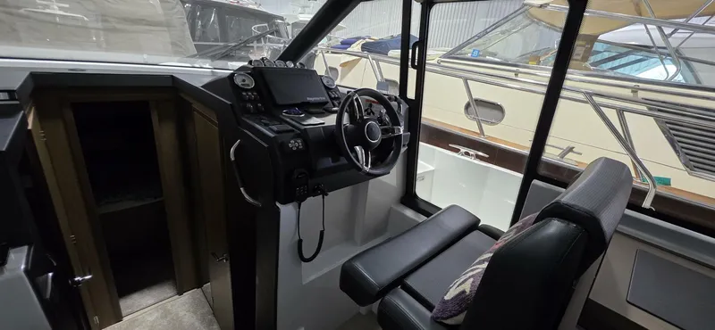  Yacht Photos Pics Helm of 2020 Jeanneau NC 37 boat with steering wheel and navigation controls.