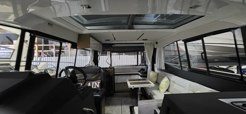  Yacht Photos Pics Interior of 2020 Jeanneau NC 37 yacht, featuring modern seating and panoramic windows.