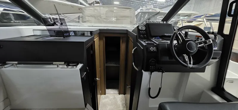 Yacht Photos Pics 2020 Jeanneau NC 37 boat interior with steering wheel and control panel.