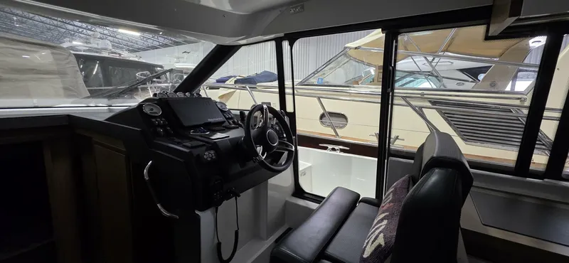  Yacht Photos Pics Interior view of 2020 Jeanneau NC 37 boat cockpit with steering wheel and controls.