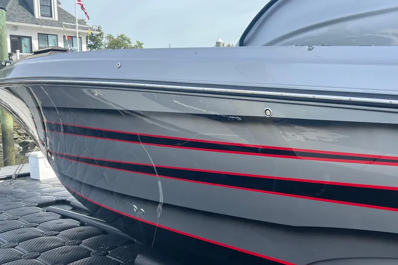  Yacht Photos Pics 2021 Fountain 39 NX boat with sleek gray and red-striped hull design.