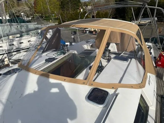 Jet Stream Yacht Photos Pics 2003 Wauquiez Centurion 45s sailboat with tan cockpit cover, docked in marina.