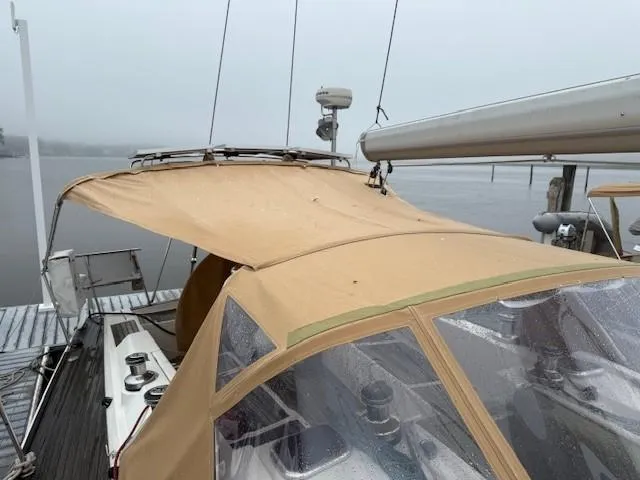 Jet Stream Yacht Photos Pics 2003 Wauquiez Centurion 45s sailboat with tan canopy docked on a foggy day.
