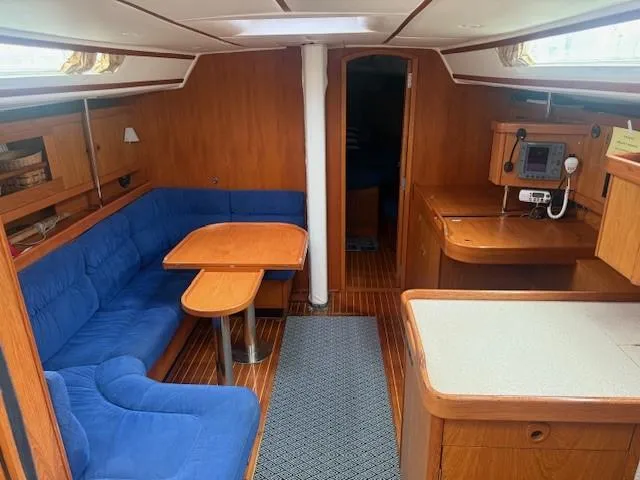 Jet Stream Yacht Photos Pics Interior of 2003 Wauquiez Centurion 45s sailboat with blue seating and wooden finishes.
