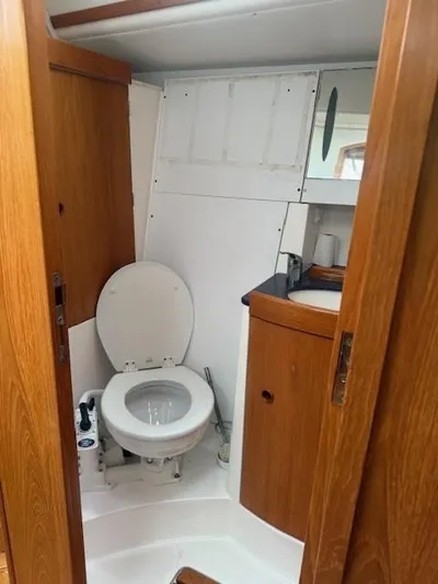 Jet Stream Yacht Photos Pics Bathroom interior of 2003 Wauquiez Centurion 45s yacht with wooden cabinetry.