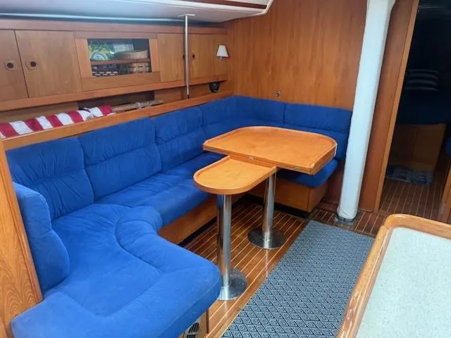 Jet Stream Yacht Photos Pics Interior of 2003 Wauquiez Centurion 45s yacht with blue seating and wooden table.
