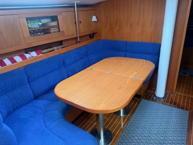 Jet Stream Yacht Photos Pics Interior of 2003 Wauquiez Centurion 45s yacht with blue seating and wooden table.
