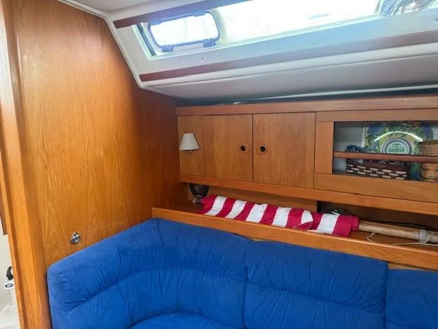 Jet Stream Yacht Photos Pics Interior of 2003 Wauquiez Centurion 45s yacht with blue seating and wooden cabinets.
