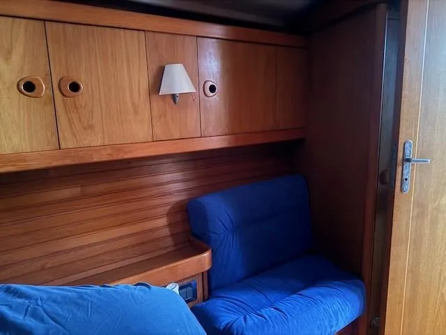 Jet Stream Yacht Photos Pics Cozy wooden cabin interior with blue seating on a 2003 Wauquiez Centurion 45s yacht.