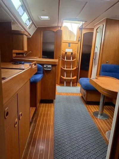 Jet Stream Yacht Photos Pics Interior of 2003 Wauquiez Centurion 45s yacht with wooden finish and blue seating.
